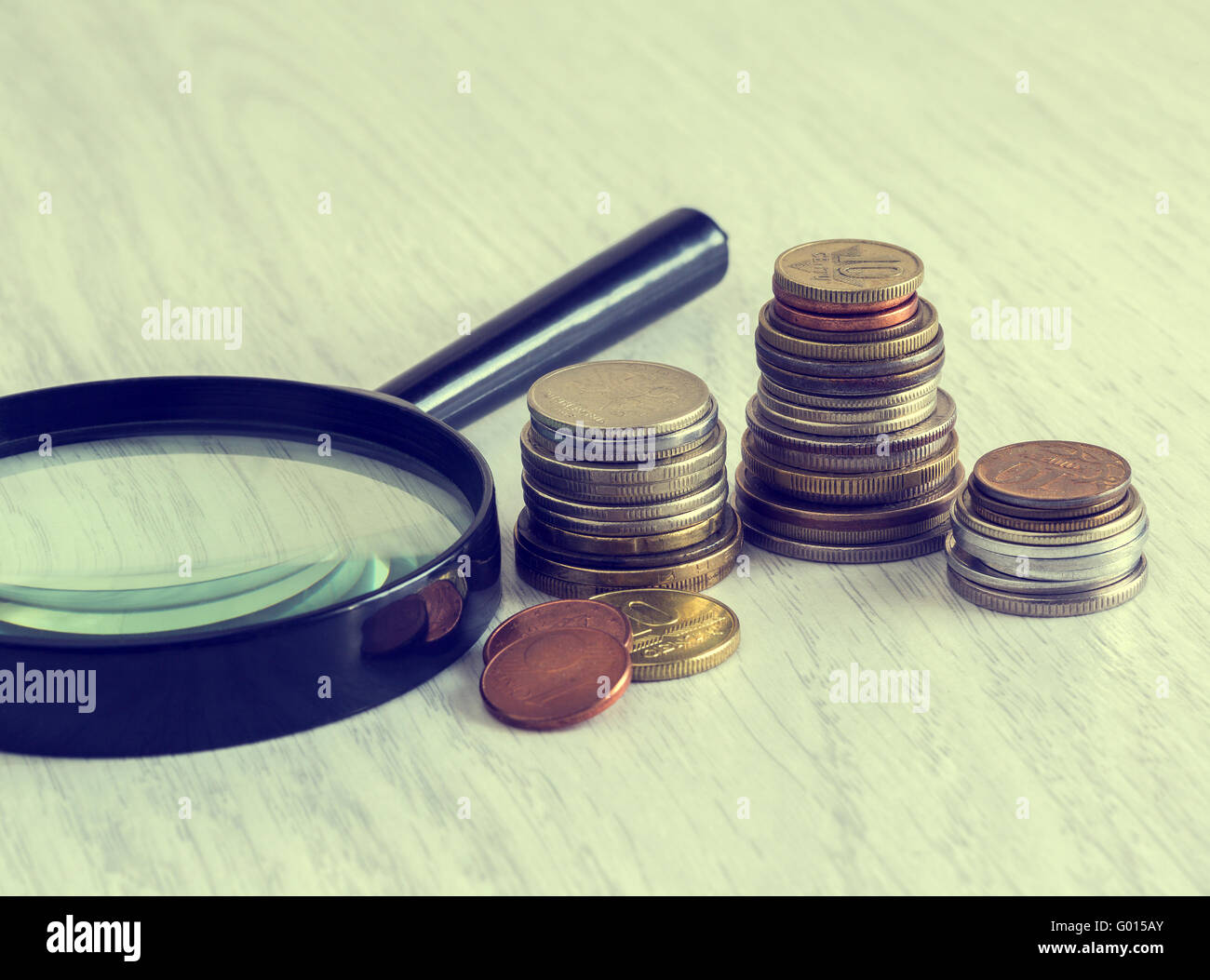coins and magnifying glass Stock Photo Alamy