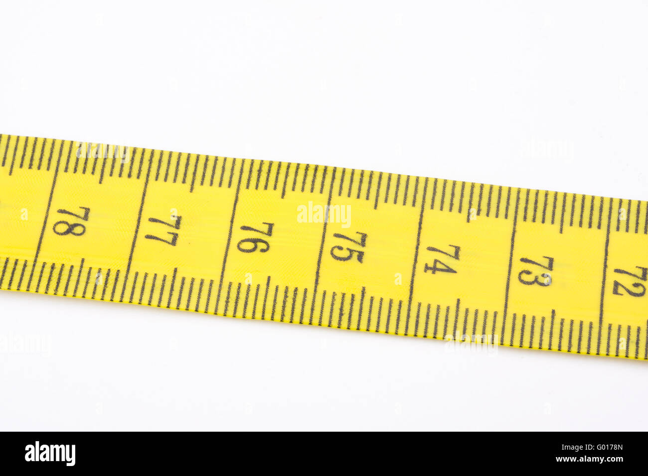 yellow measuring tape used by tailors on white Stock Photo Alamy