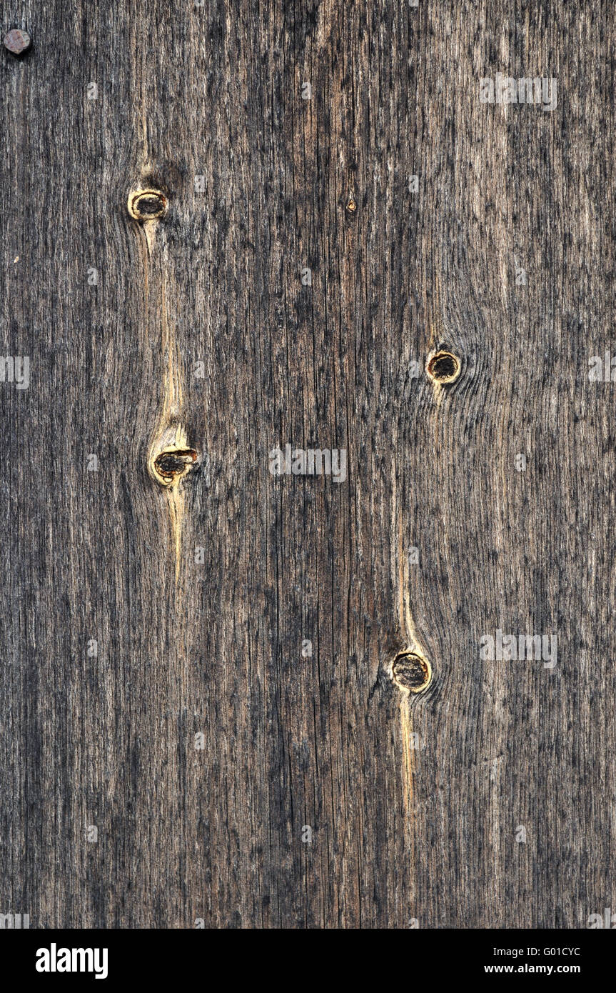 Close up of dark weathered wooden background with knots Stock Photo