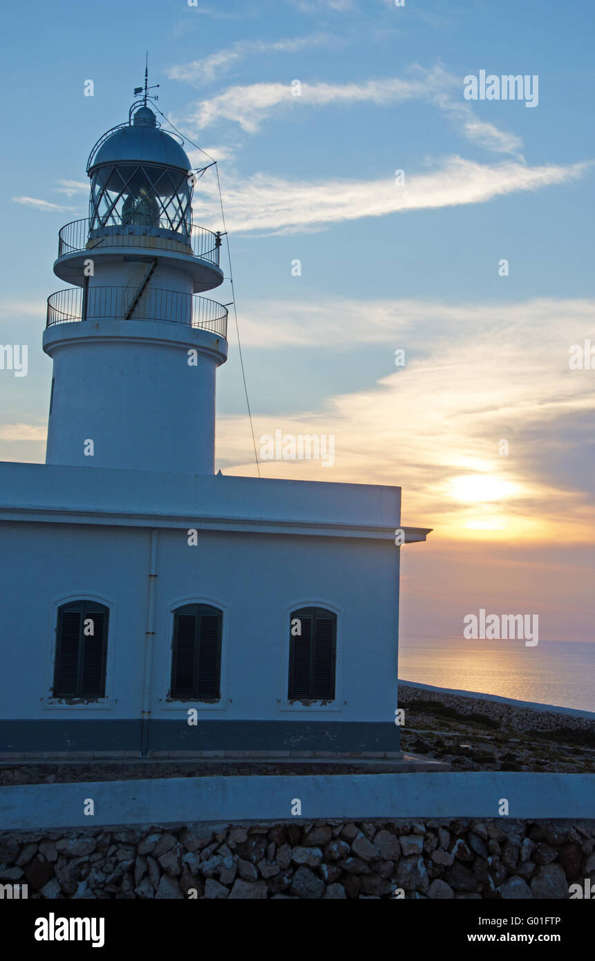 Minorca, Balearic islands, Spain: sunset at Cap de Cavalleria lighthouse, built on a cape that was the scene of numerous shipwrecks throughout history Stock Photo