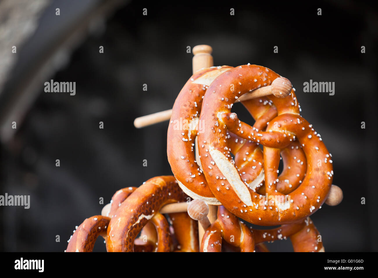 Pretzels traditional german snacks are hanging on the wooden stand