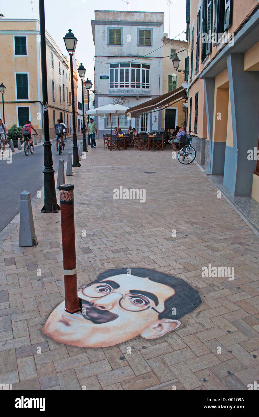 Menorca, Balearic Islands, Spain, Europe: street art in the center of Ciutadella, a pole turned into Groucho Marx cigar on a sidewalk Stock Photo