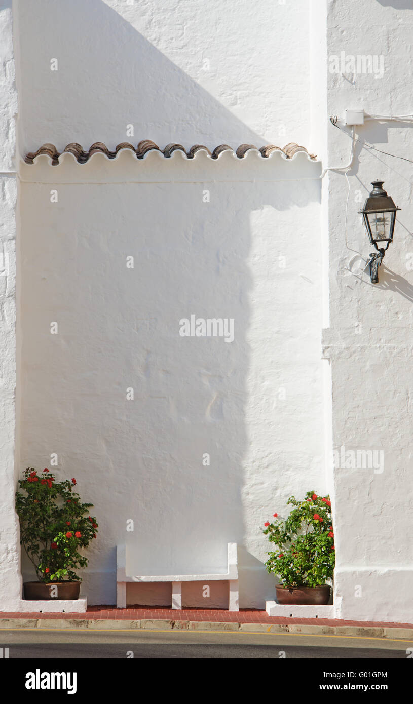 Menorca: a bench in the whitewashed fishing village of Fornells, located in a bay in the north of the island Stock Photo