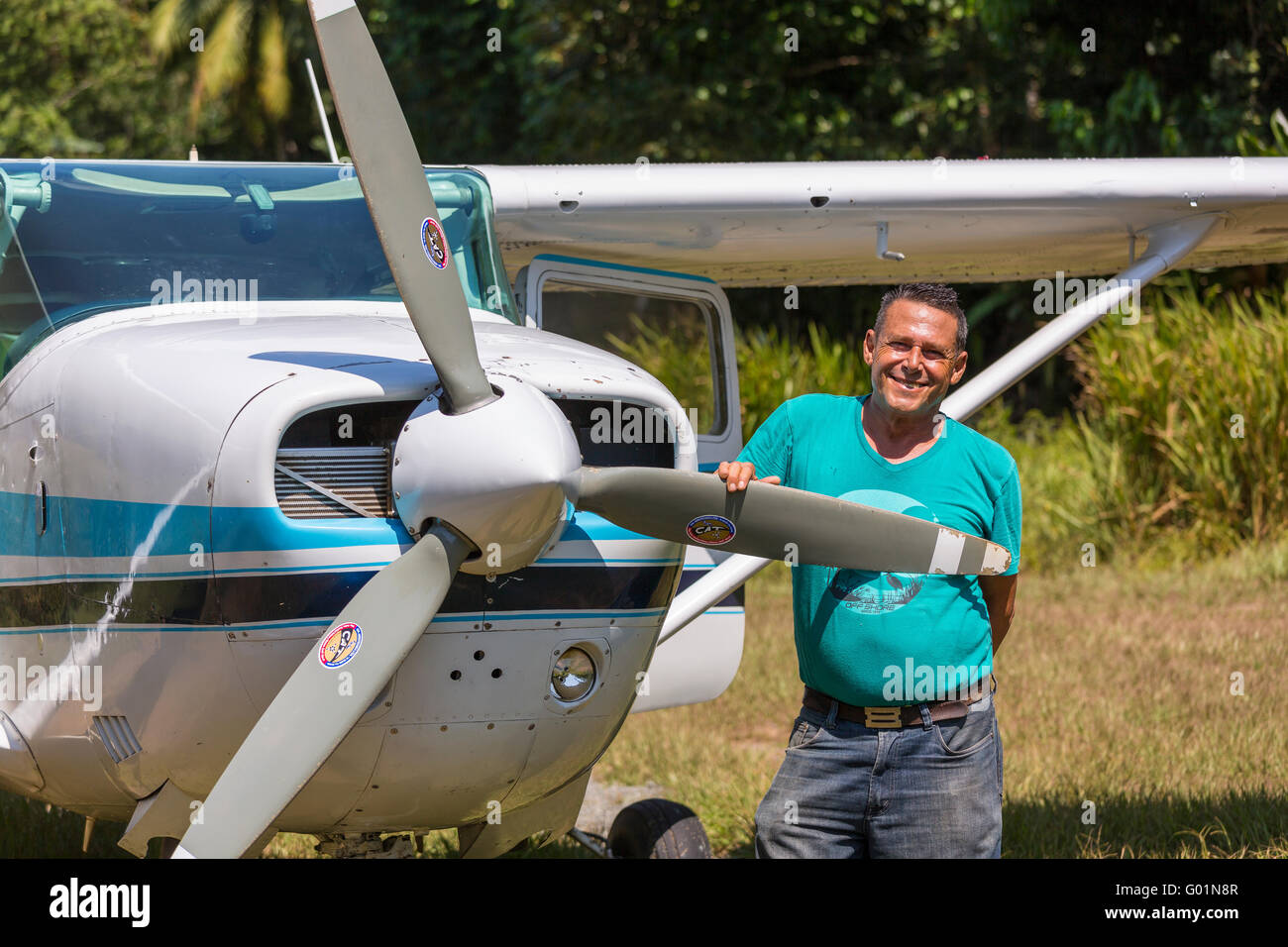 CORCOVADO NATIONAL PARK, COSTA RICA - Pilot next to propeller of Cessna airplane, Osa Peninsula. Stock Photo