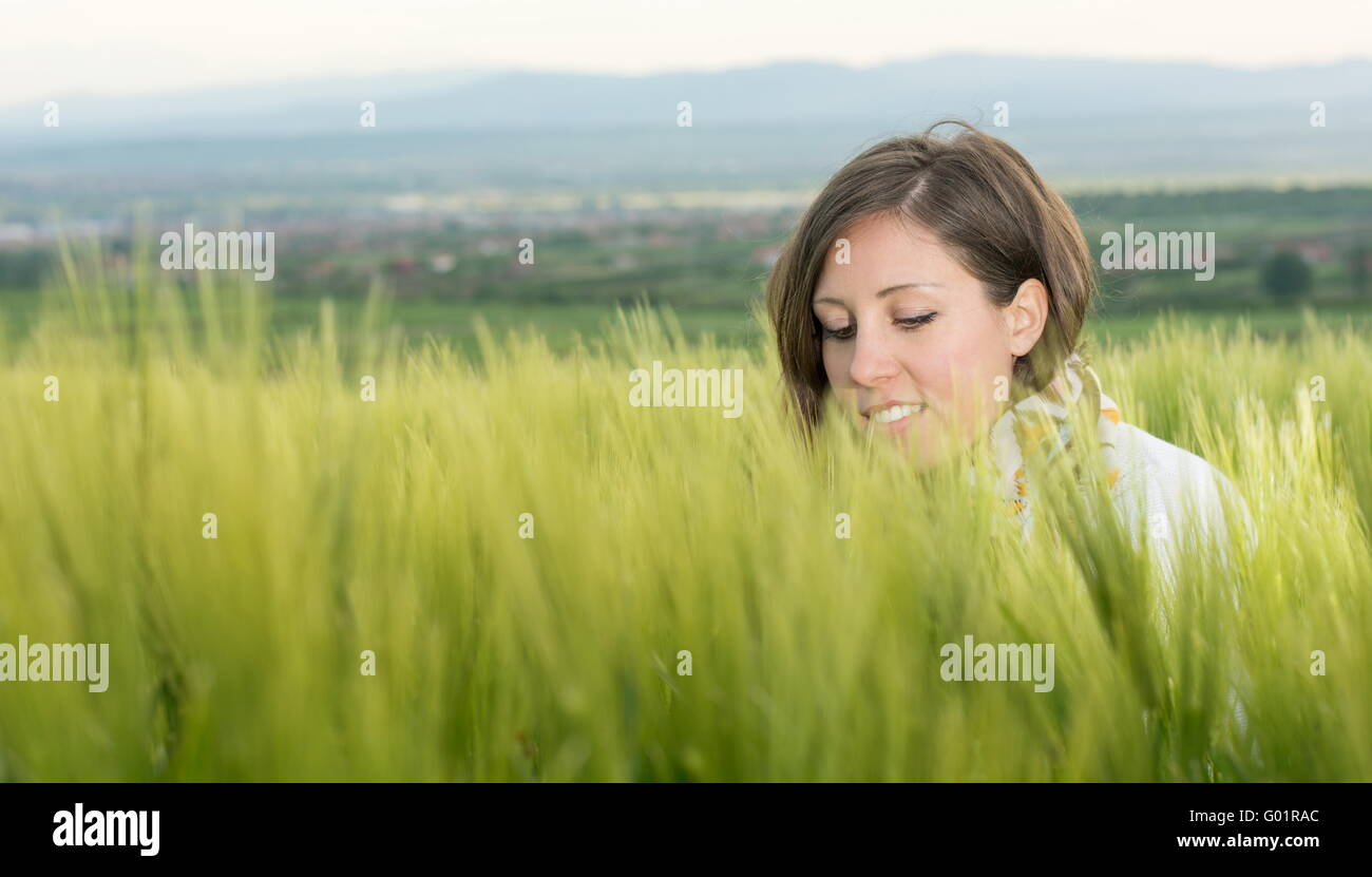 Young woman in a field of wheat Stock Photo - Alamy