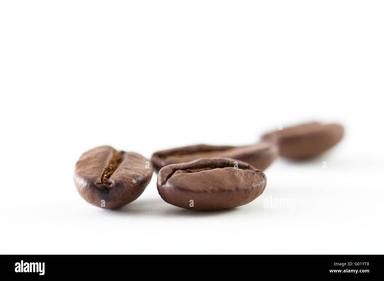 A close up shoot of some coffee beans isolated on white background ...