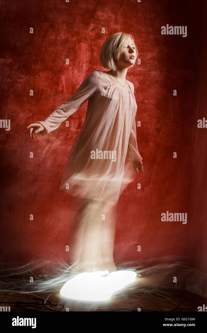 Ghost digital girl on red grunge wall Stock Photo