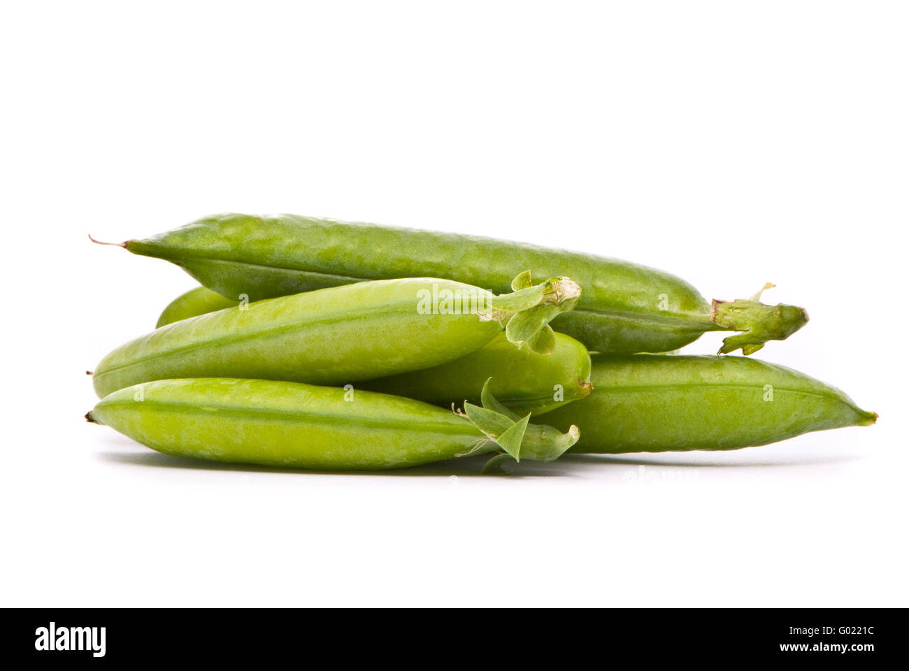 Pods of fresh green peas on a white background Stock Photo