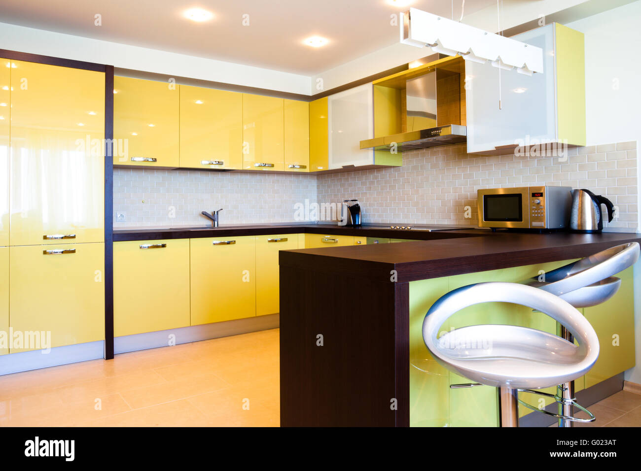 Yellow kitchen interior with chairs in modern flat Stock Photo Alamy
