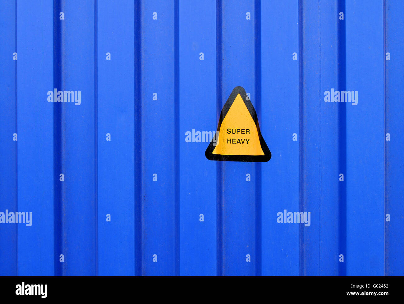 Blue sidewall of a cargo container with a super heavy sign Stock Photo