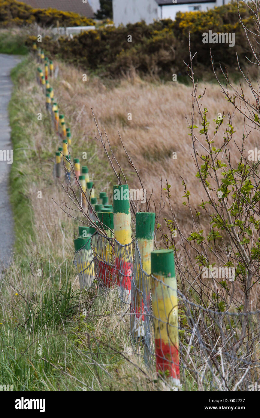 A line of coloured wooden fencing posts on Arranmore, County Donegal