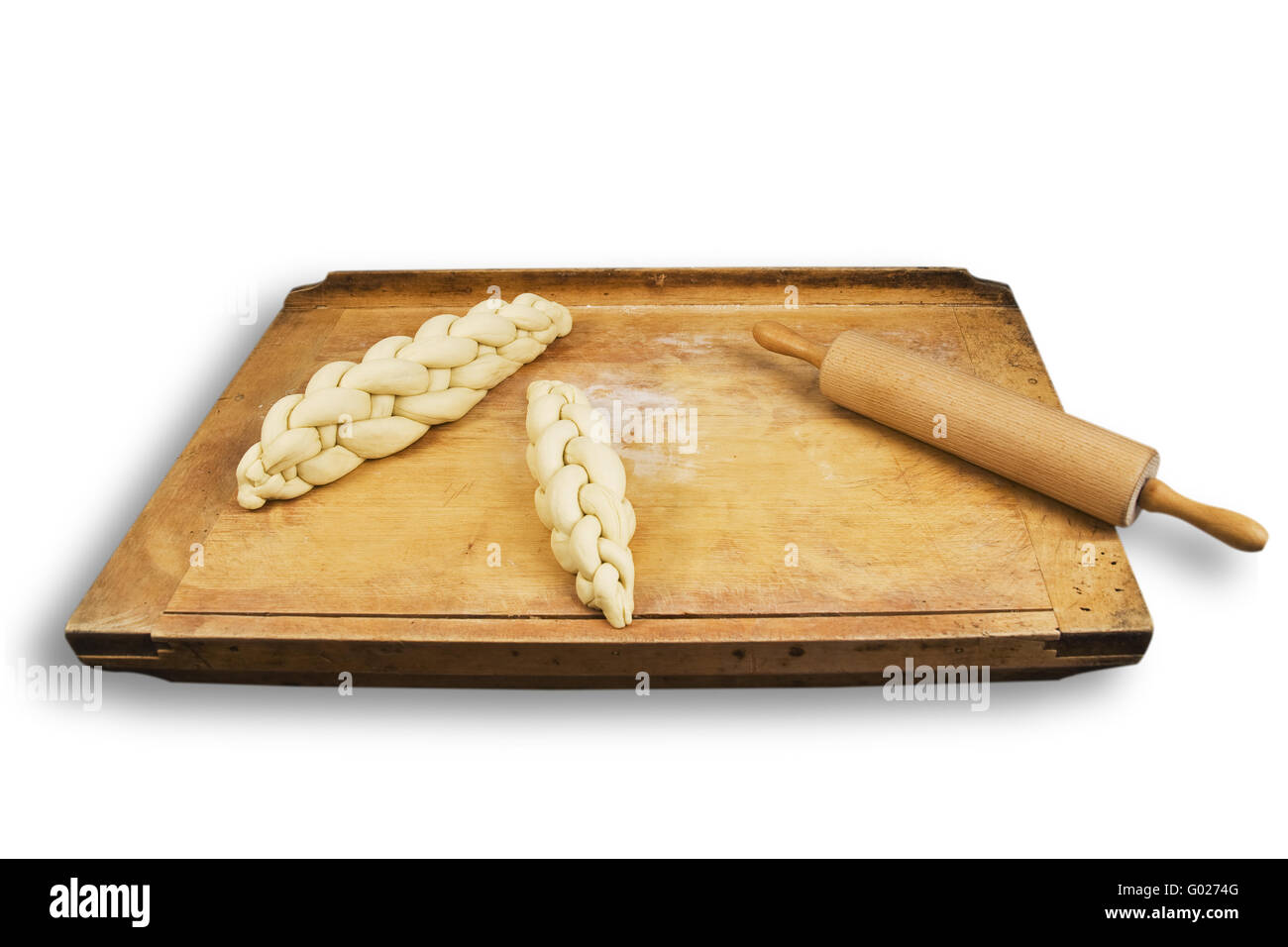 to braid plaited loaf on a breadboard Stock Photo