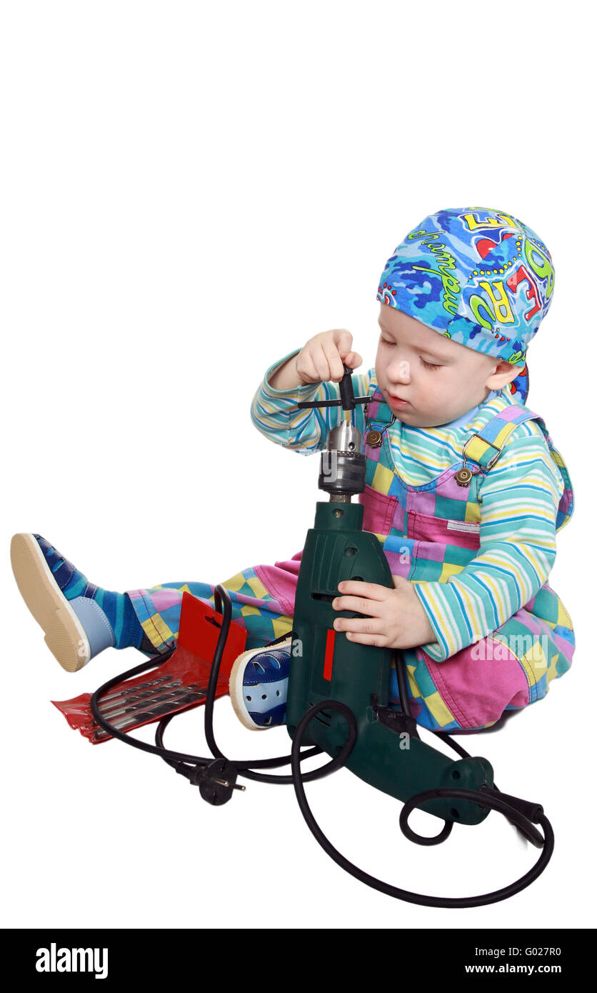 The twoyearold boy plays with the tool drill left by parents Stock