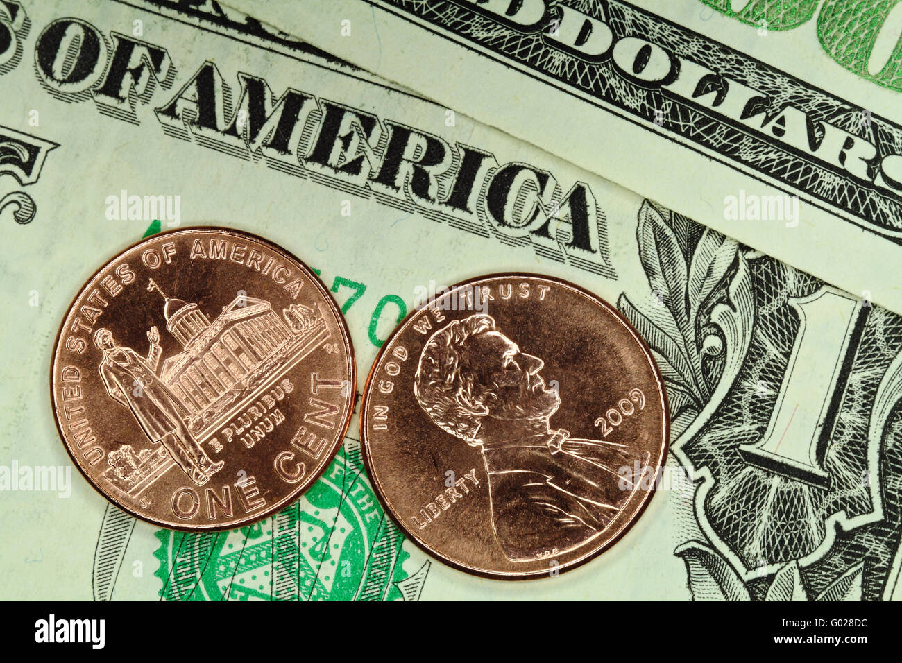 Two commemorative cent coins are on the U.S. bills Stock Photo