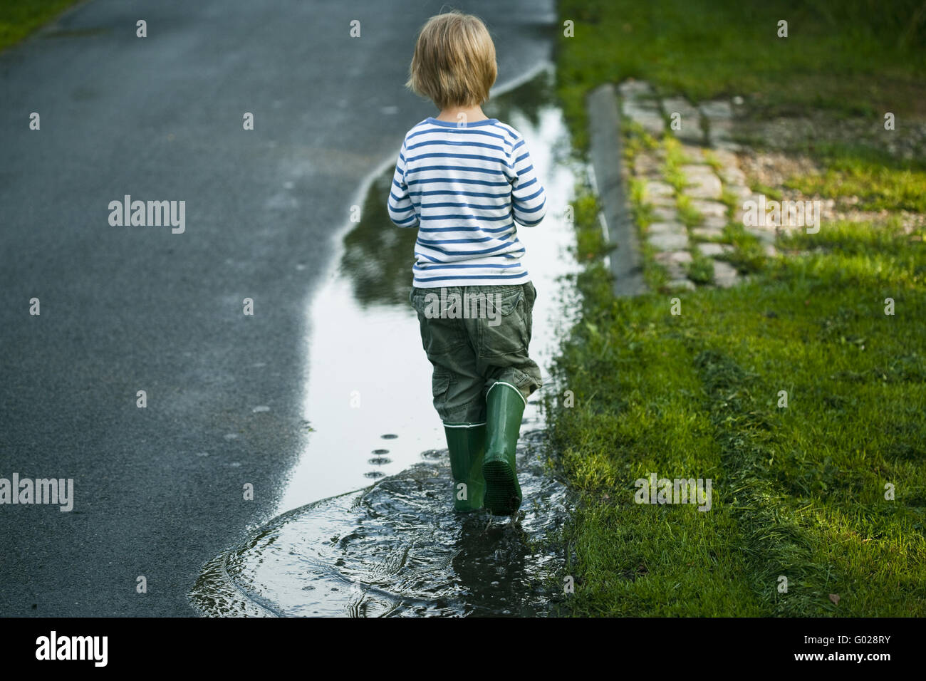 Boy in a puddle Stock Photo