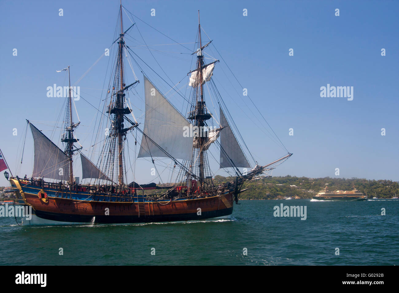 Historic tall ship cruising in Sydney Harbour with Manly ferry in background Sydney NSW Australia Stock Photo