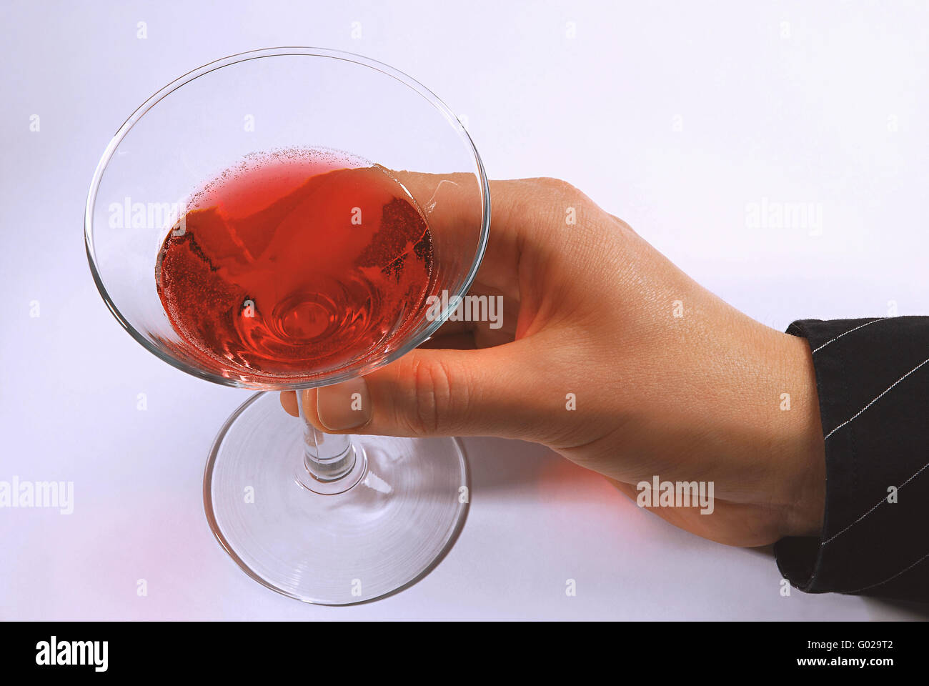hand holding cocktail glass Stock Photo