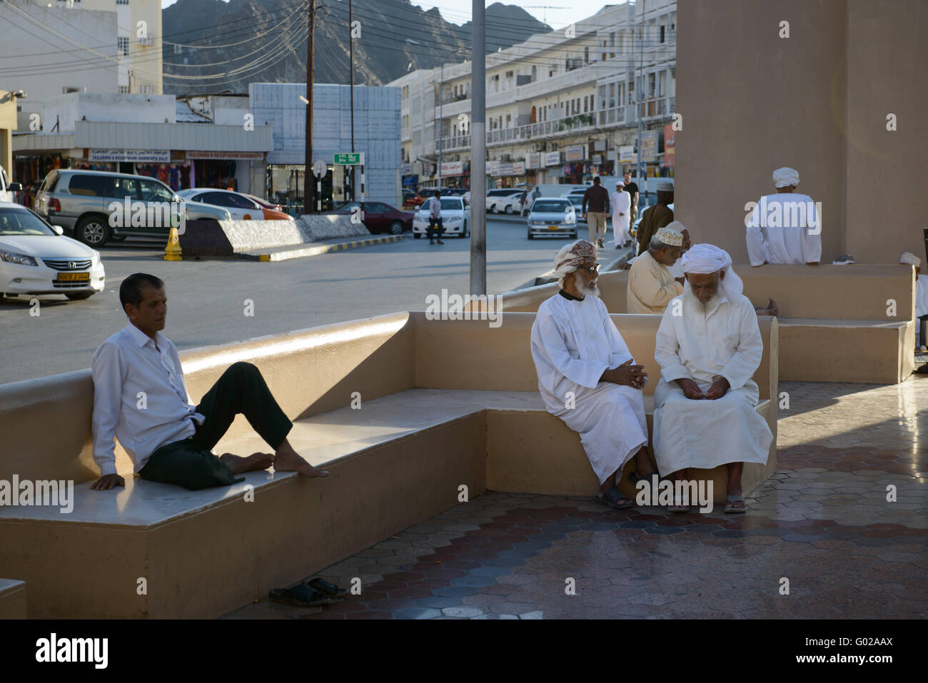 Omani men conversing on the streets of Muscat. Stock Photo