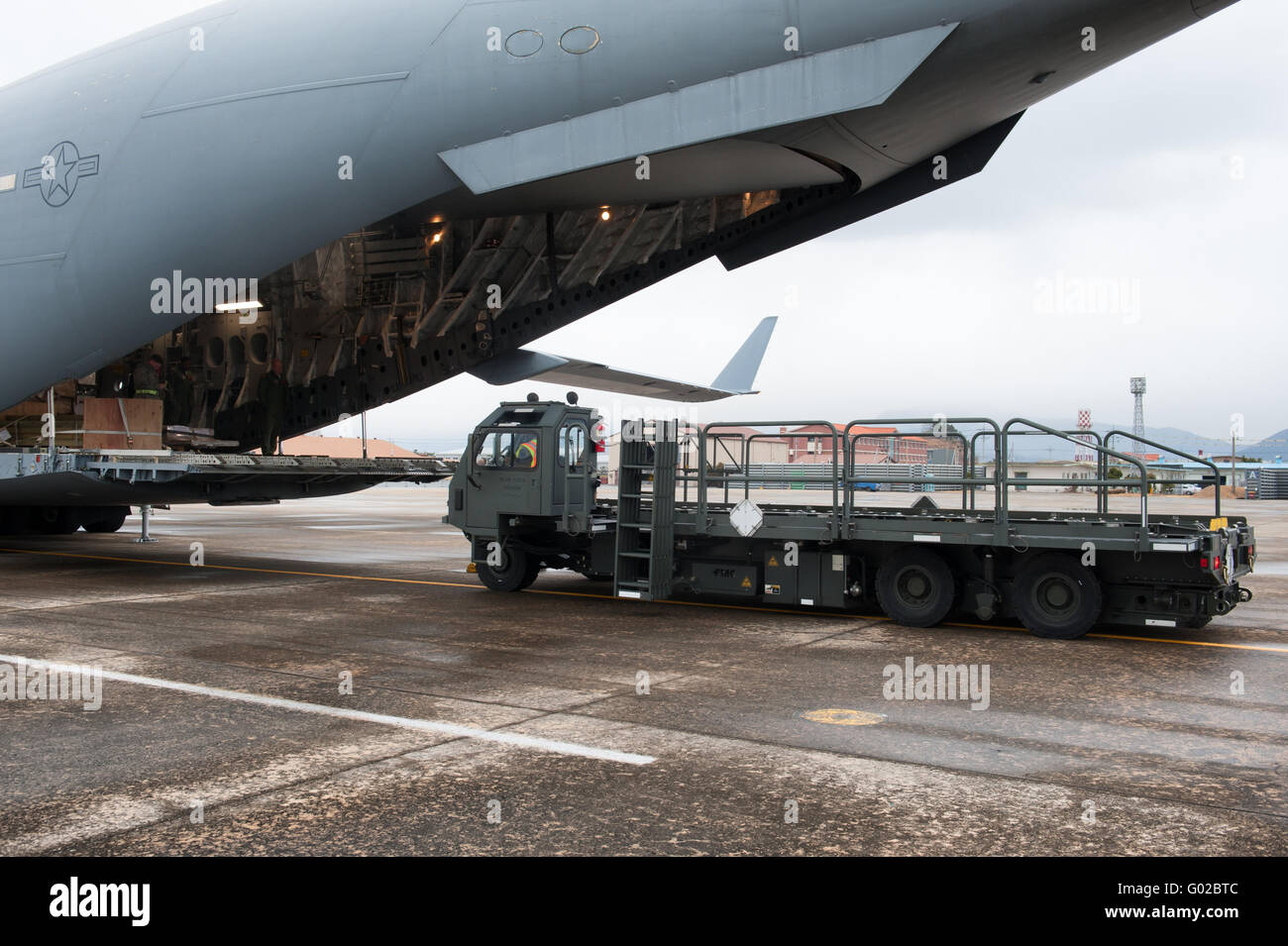 Busan, South Korea - 28 February 2012:  A 25K loader lines up to off load cargo. Stock Photo
