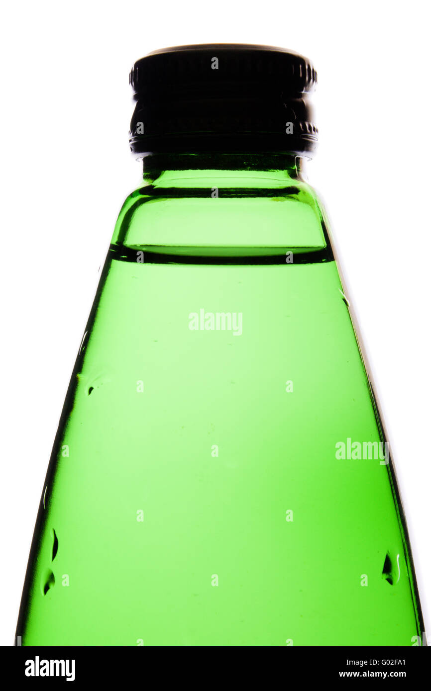 clean mineral water in a green glass bottle it is isolated on white