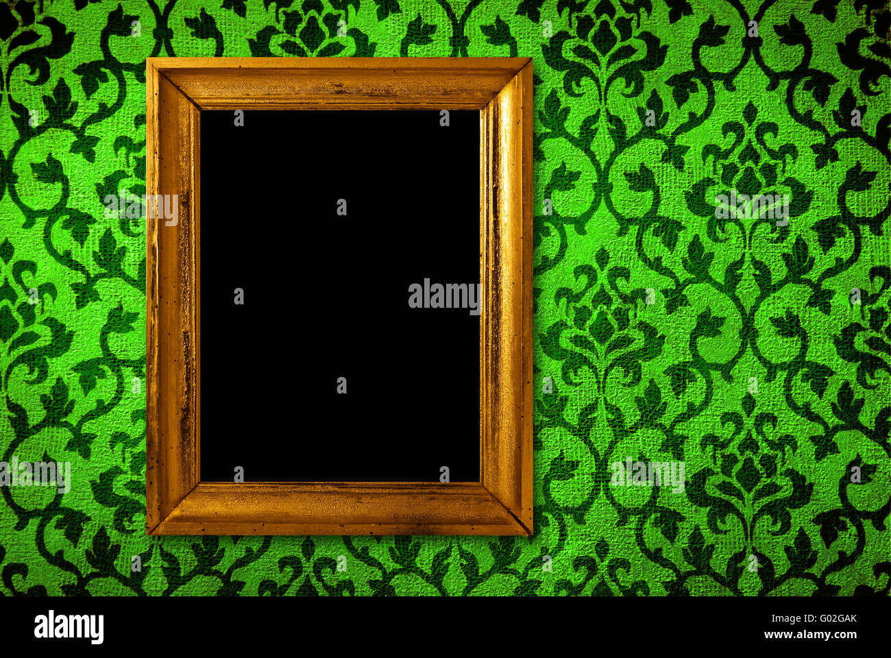 Gold frame on a vintage green wall background Stock Photo - Alamy