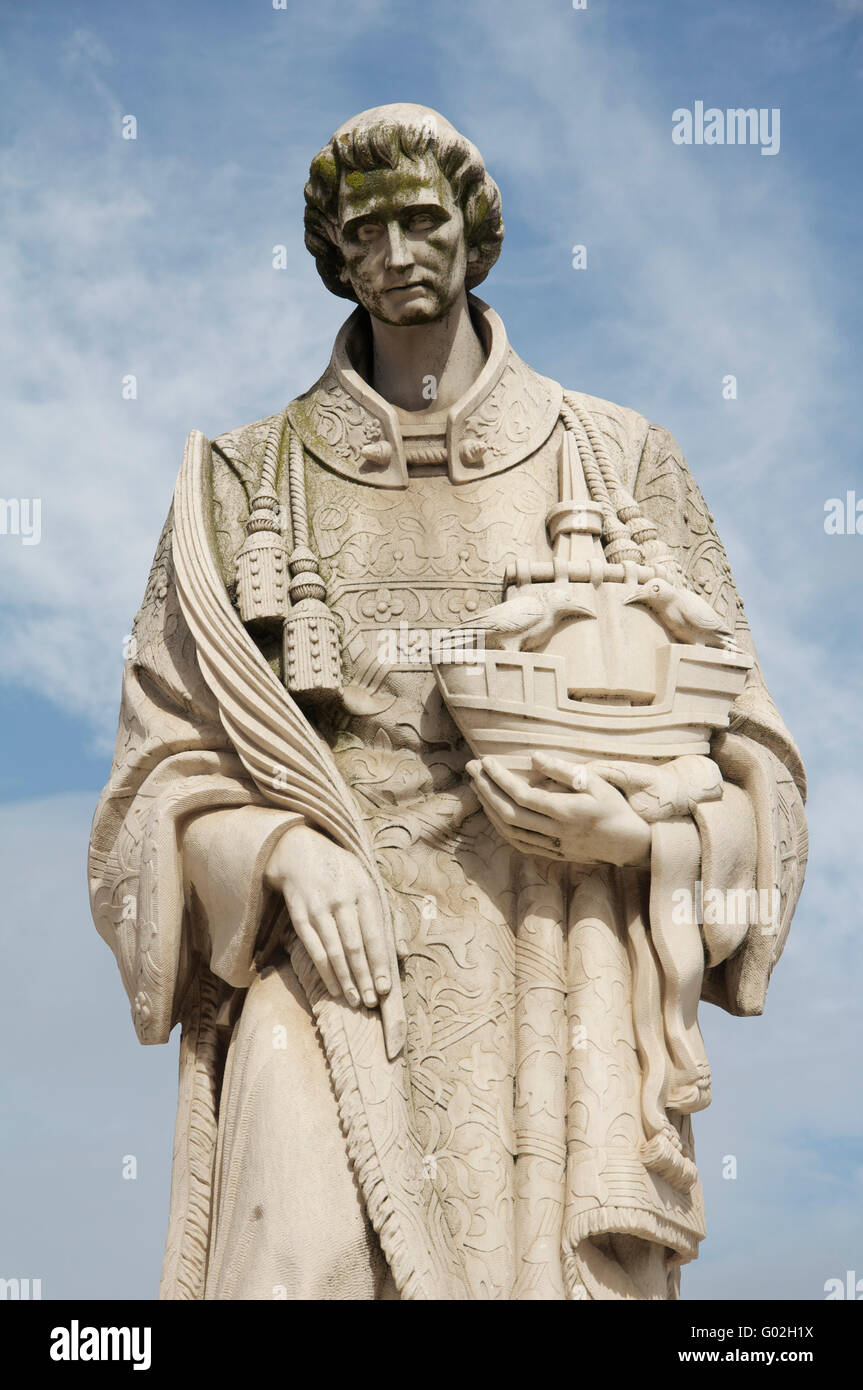 A marble statue of the martyr São Vicente, patron Saint of Lisbon. He holds a ship with two ravens, the city's emblem. Portugal. Stock Photo