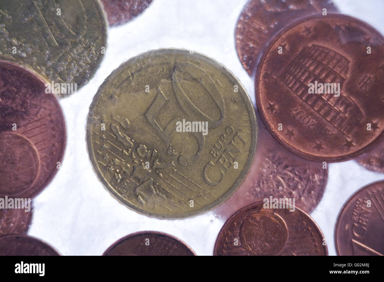 coins in ice Stock Photo