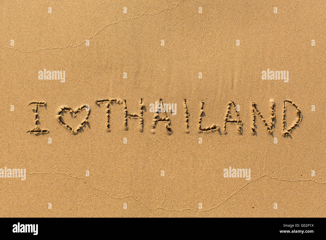 I love Thailand - the inscription by hand on the beach sand. Stock Photo