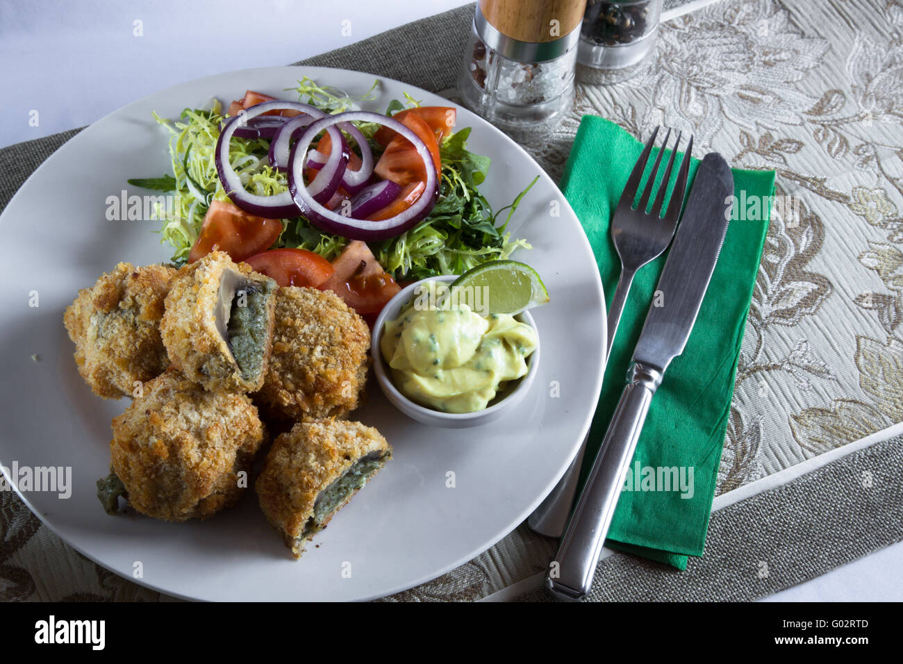 A portion/serving of homemade Stuffed Breaded Mushrooms with a Garlic