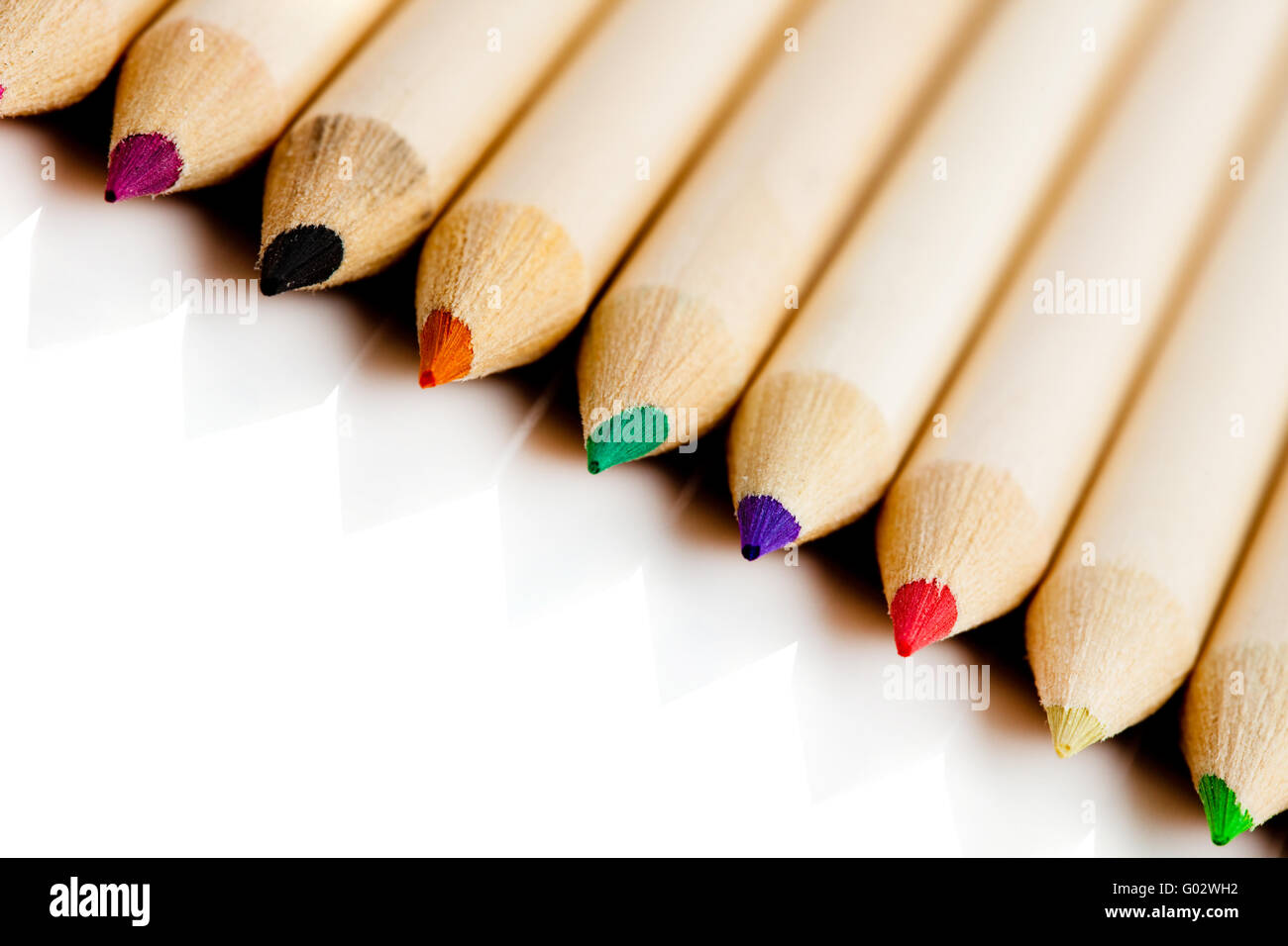many colored pencils in row over white background Stock Photo Alamy