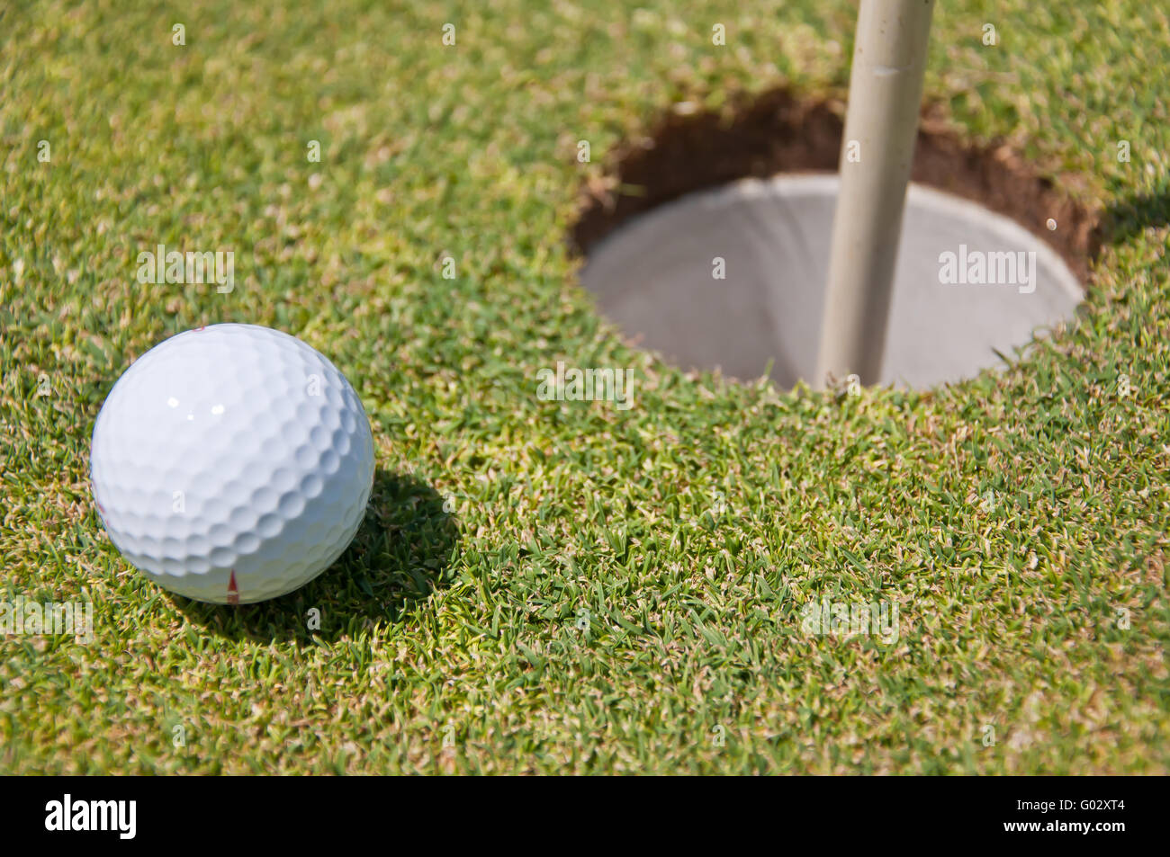 golf hole with ball and flag Stock Photo