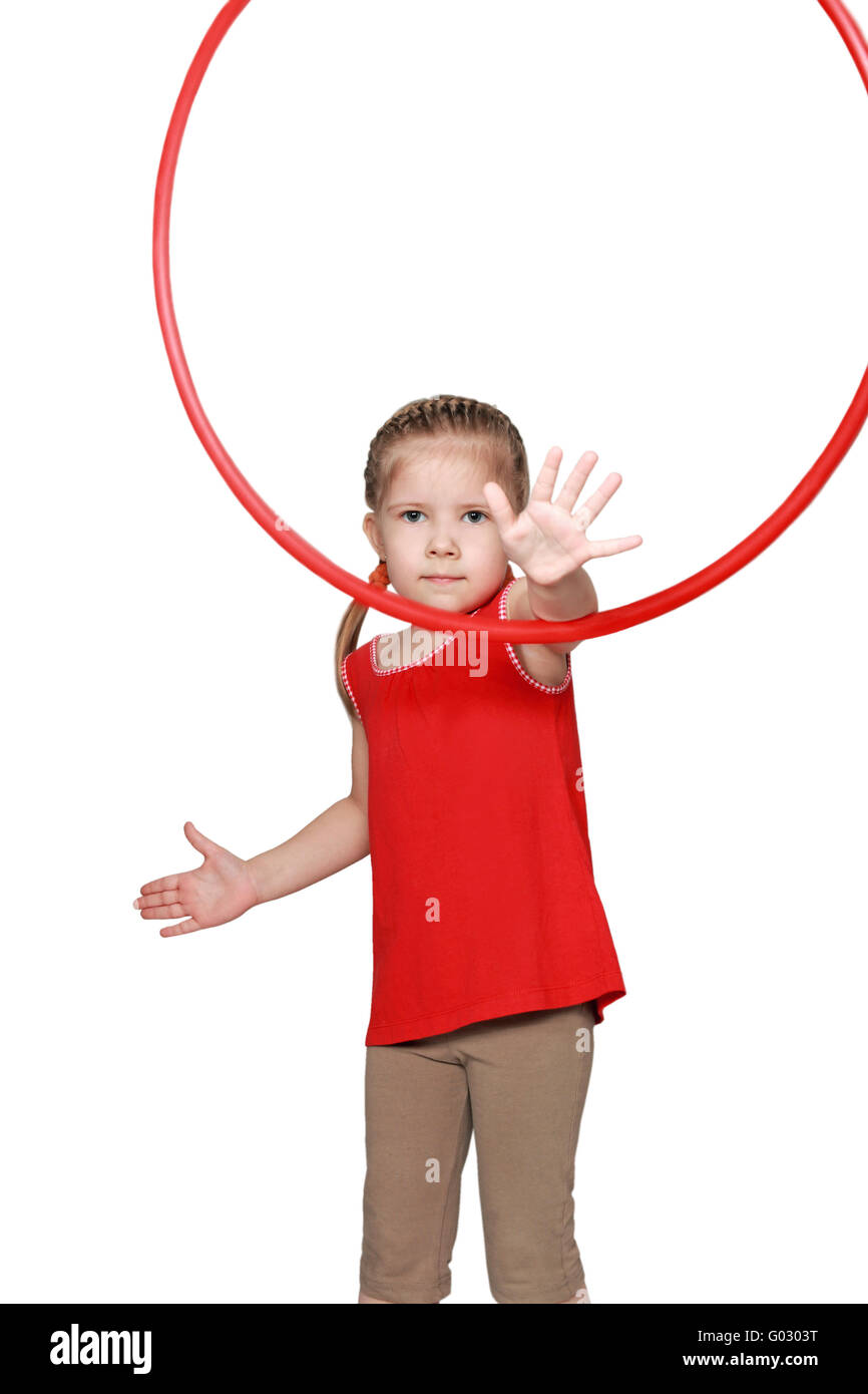 The child carries out one of elements of gymnastic exercise. The expressive person of the girl Stock Photo