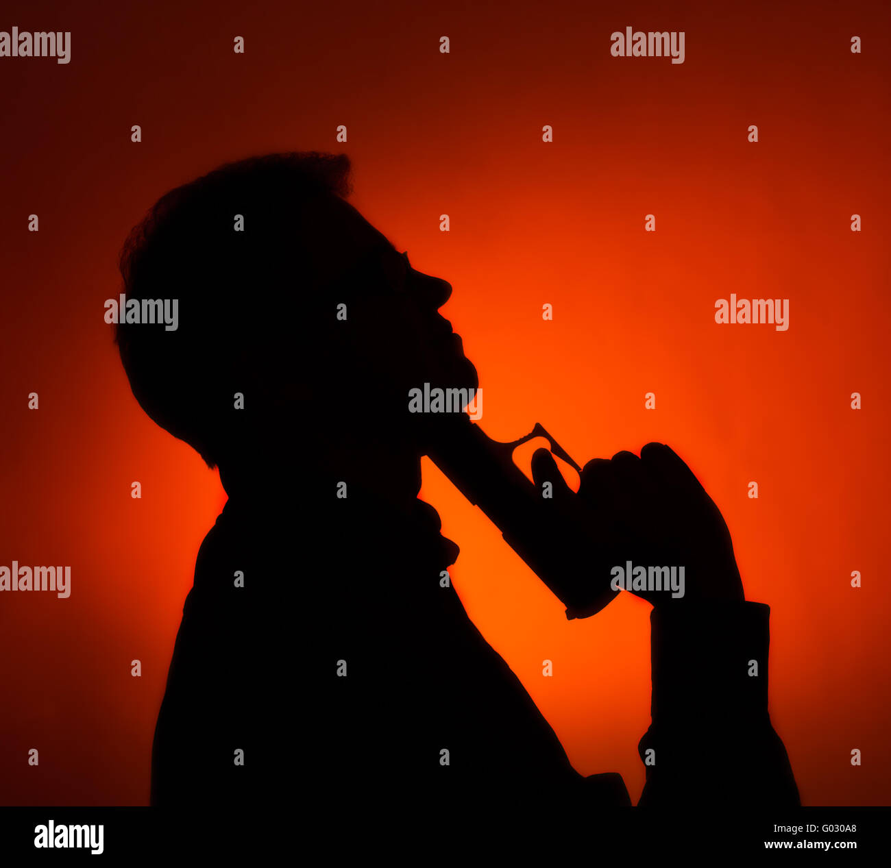 silhouette of the man pointing gun to his head Stock Photo