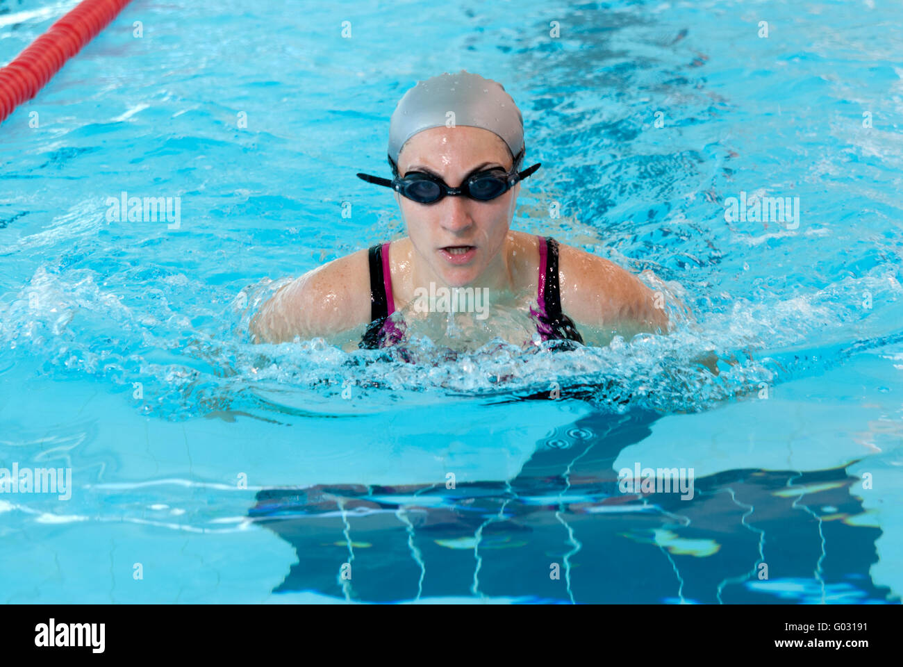 young woman swim on indoor pool close-up. breastroke style. Stock Photo