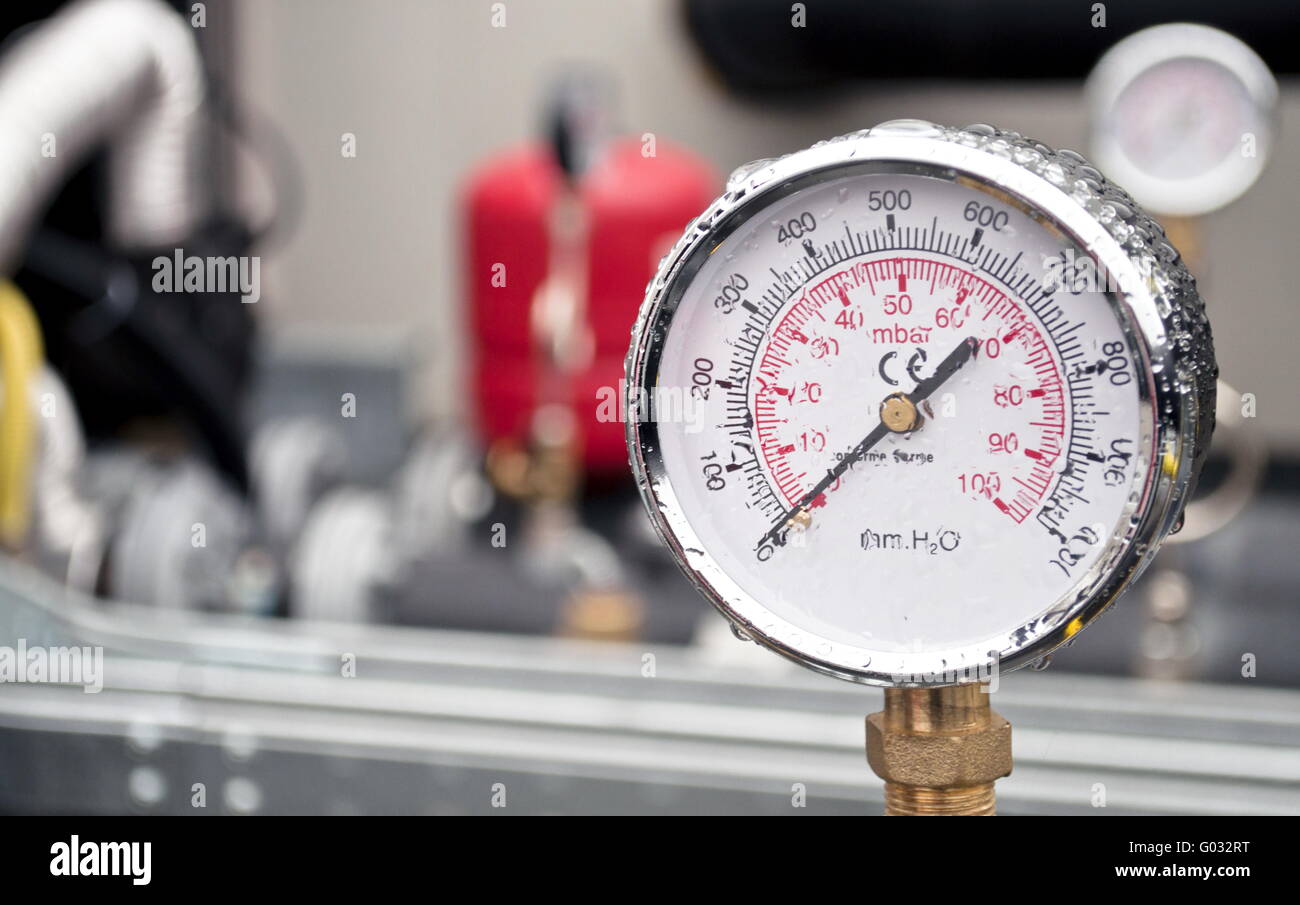 Industrial hydraulic round barometer with rain over it Stock Photo - Alamy