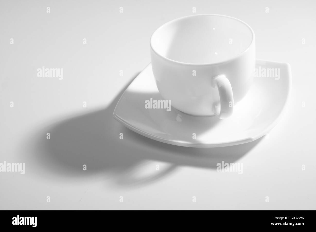 An empty coffee cup on a gray background with shadow Stock Photo