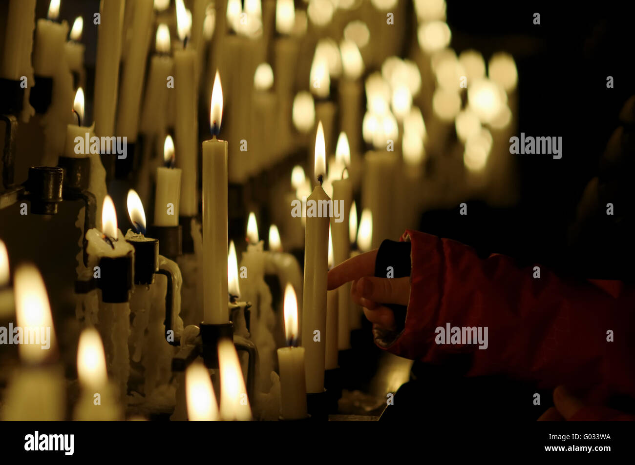 votive candles hand Stock Photo