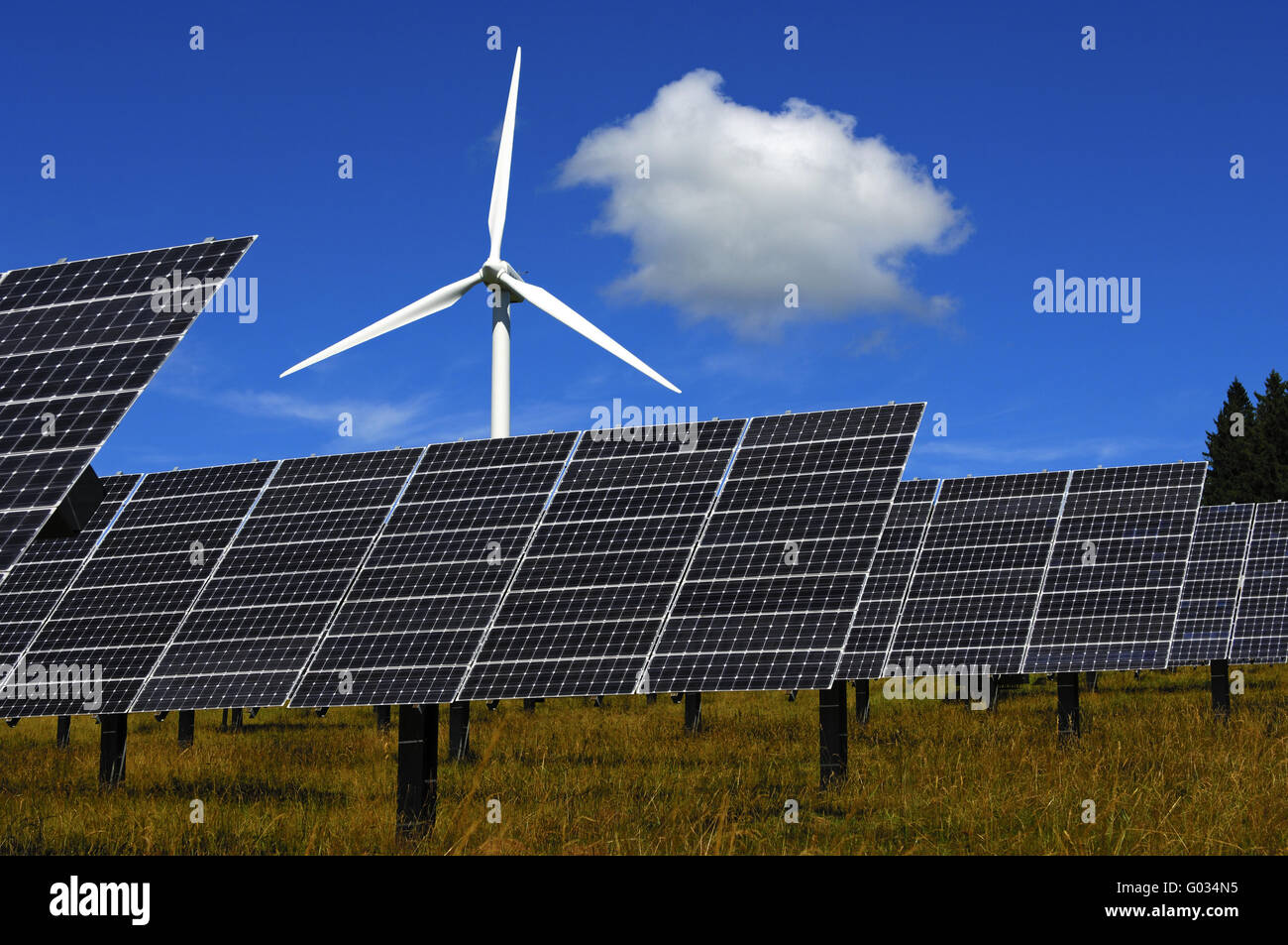 Green energy, solar panels and a wind turbine Stock Photo