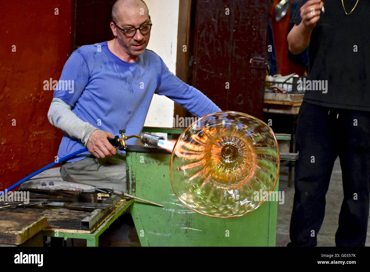 Glass blowers making glass at the glass factory on Murano island, Italy