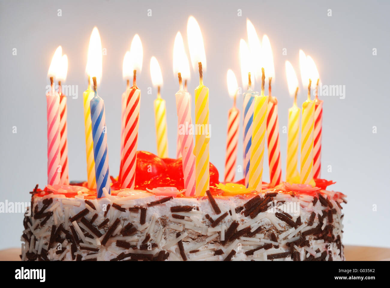 a birthday cake with lighted candles Stock Photo Alamy