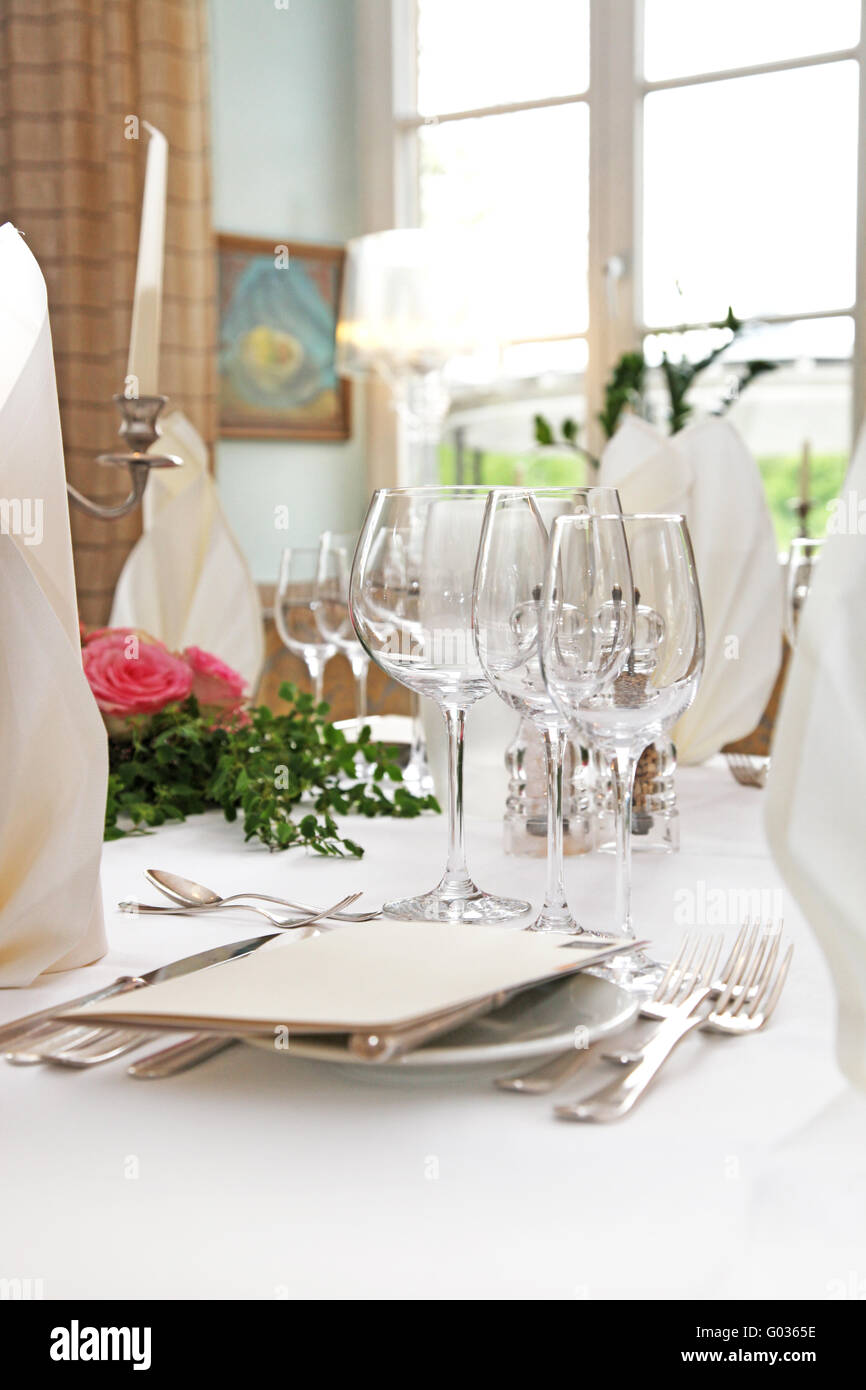 Table decoration with wine glasses and menus in th Stock Photo