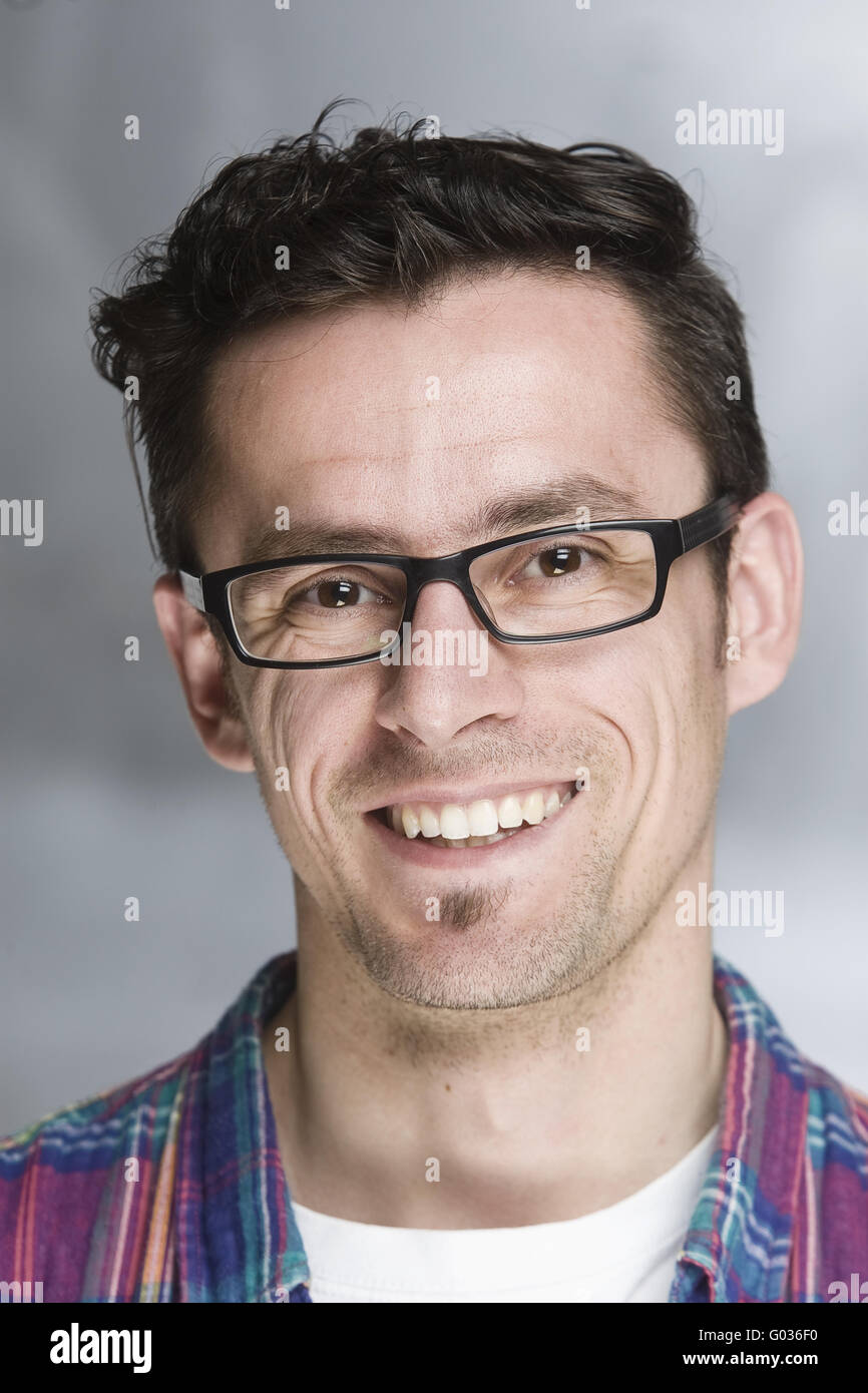 young handsome guy with glasses smiling Stock Photo