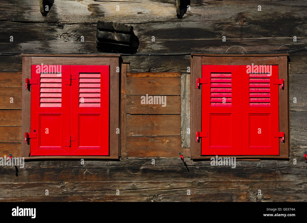 Close red shutters of a block house Stock Photo
