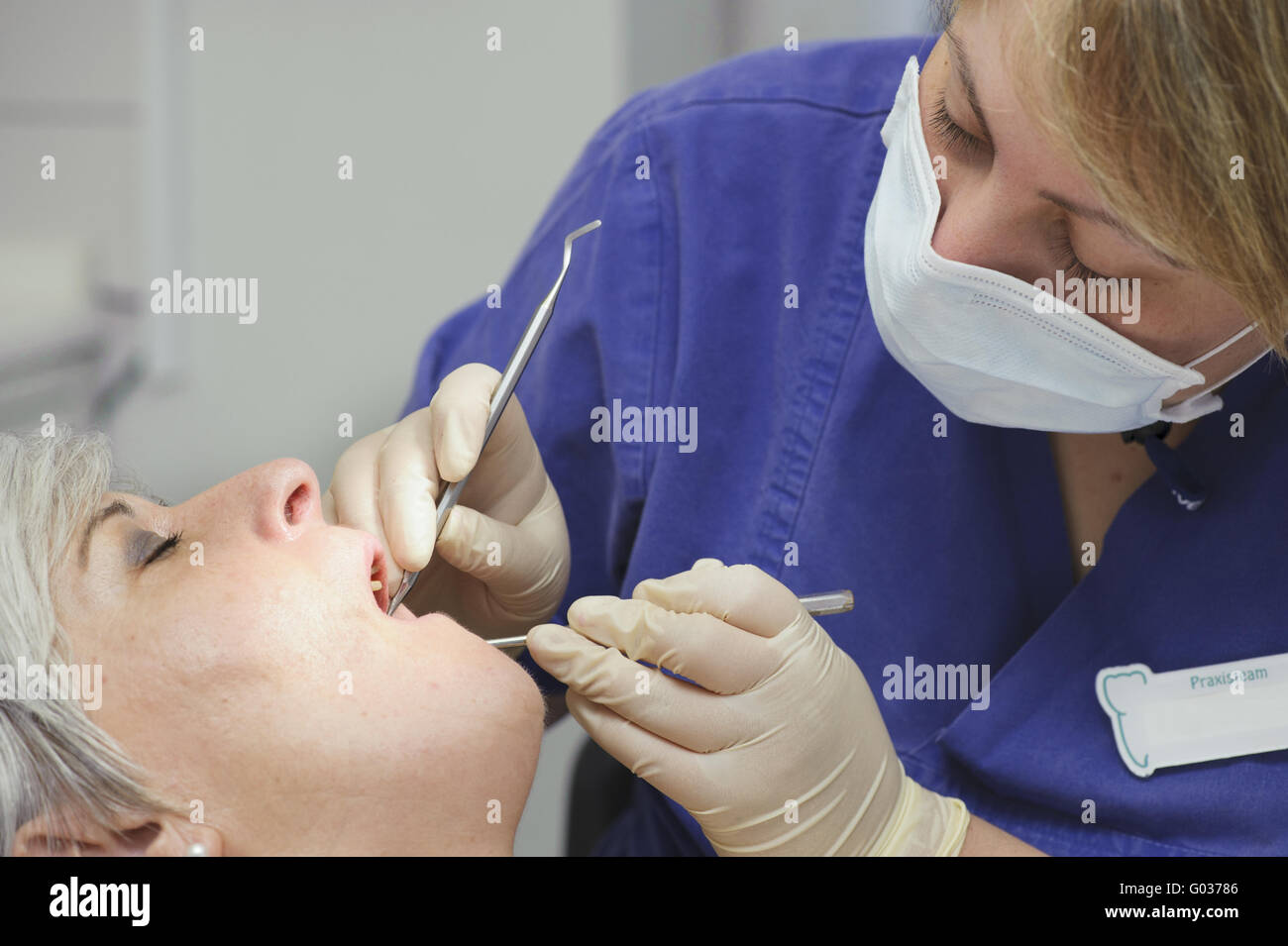 Dental assistant in dental treatment for a patient Stock Photo