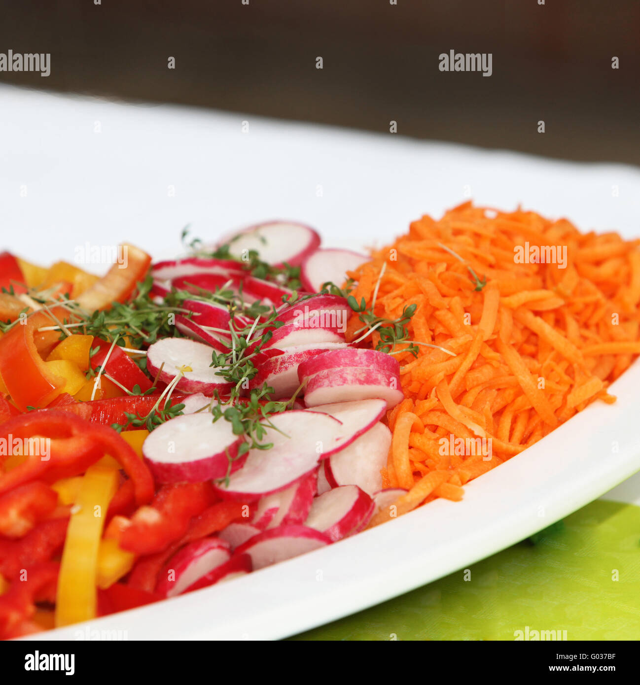 garnished, fresh salad with radishes, carrots and Stock Photo