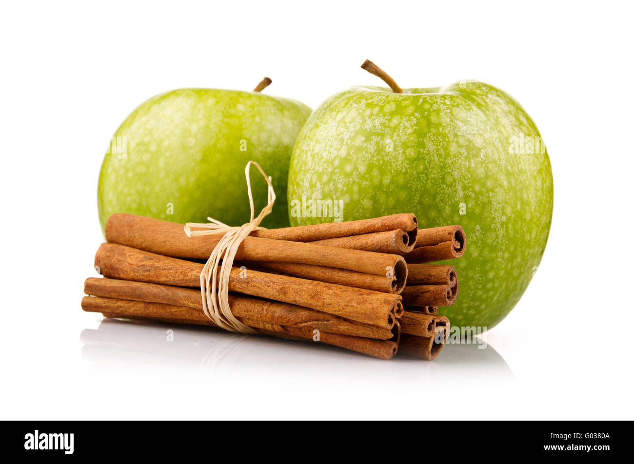 Ripe green apples with cinnamon sticks isolated Stock Photo
