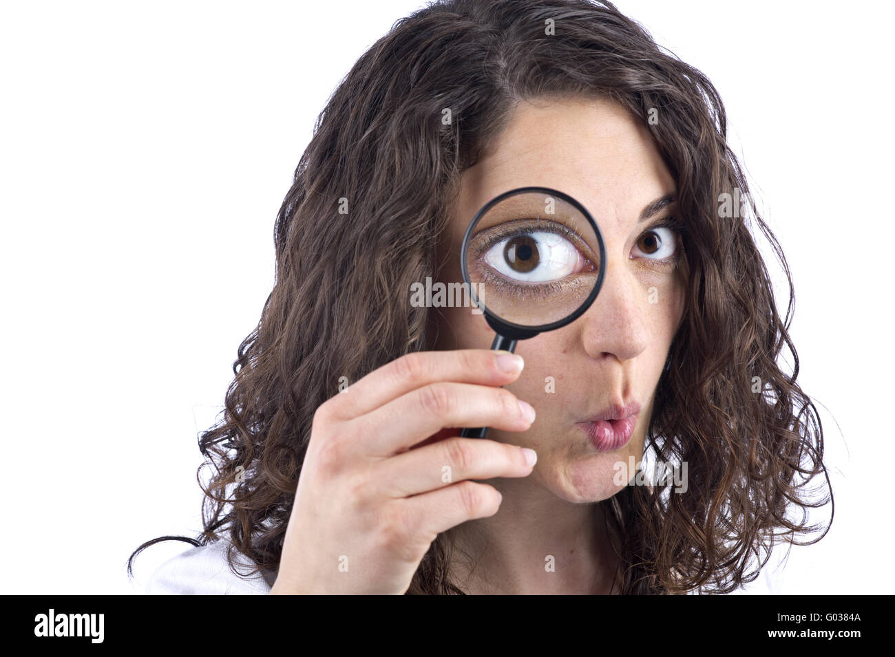 Woman with magnifying glass in front of the face Stock Photo