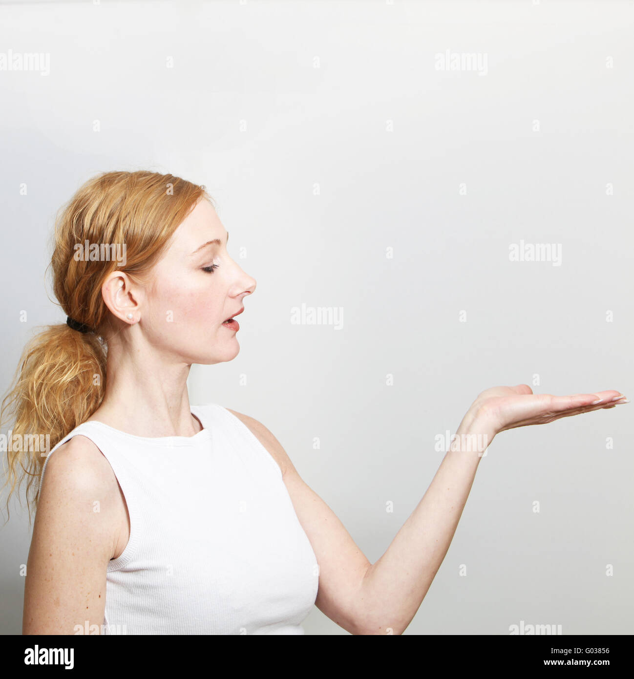 Woman presenting something on her hand - with spac Stock Photo