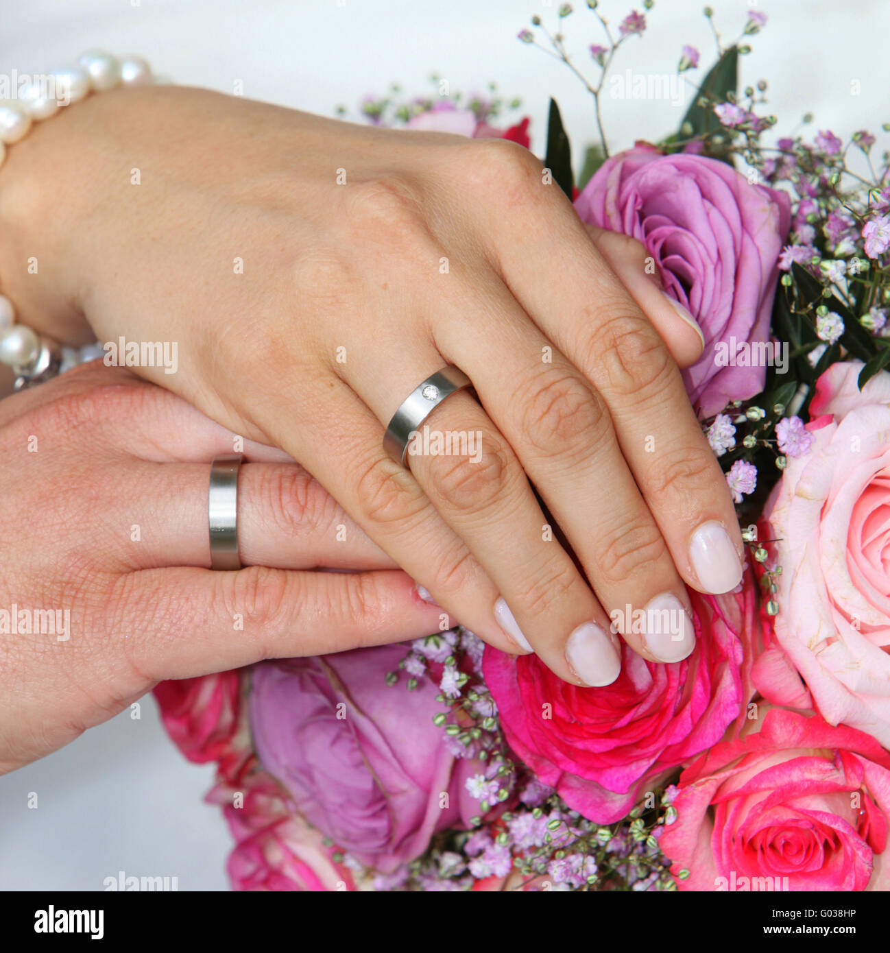 Hands of a bride and groom with wedding rings Stock Photo