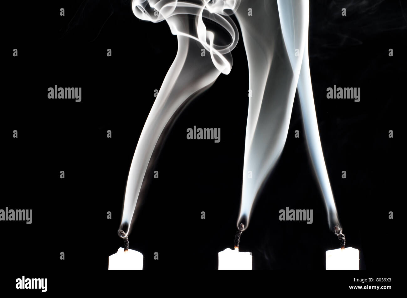 3 smoking candles Stock Photo Alamy